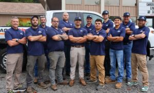 Island Airco heating and cooling team posing in front of white company van